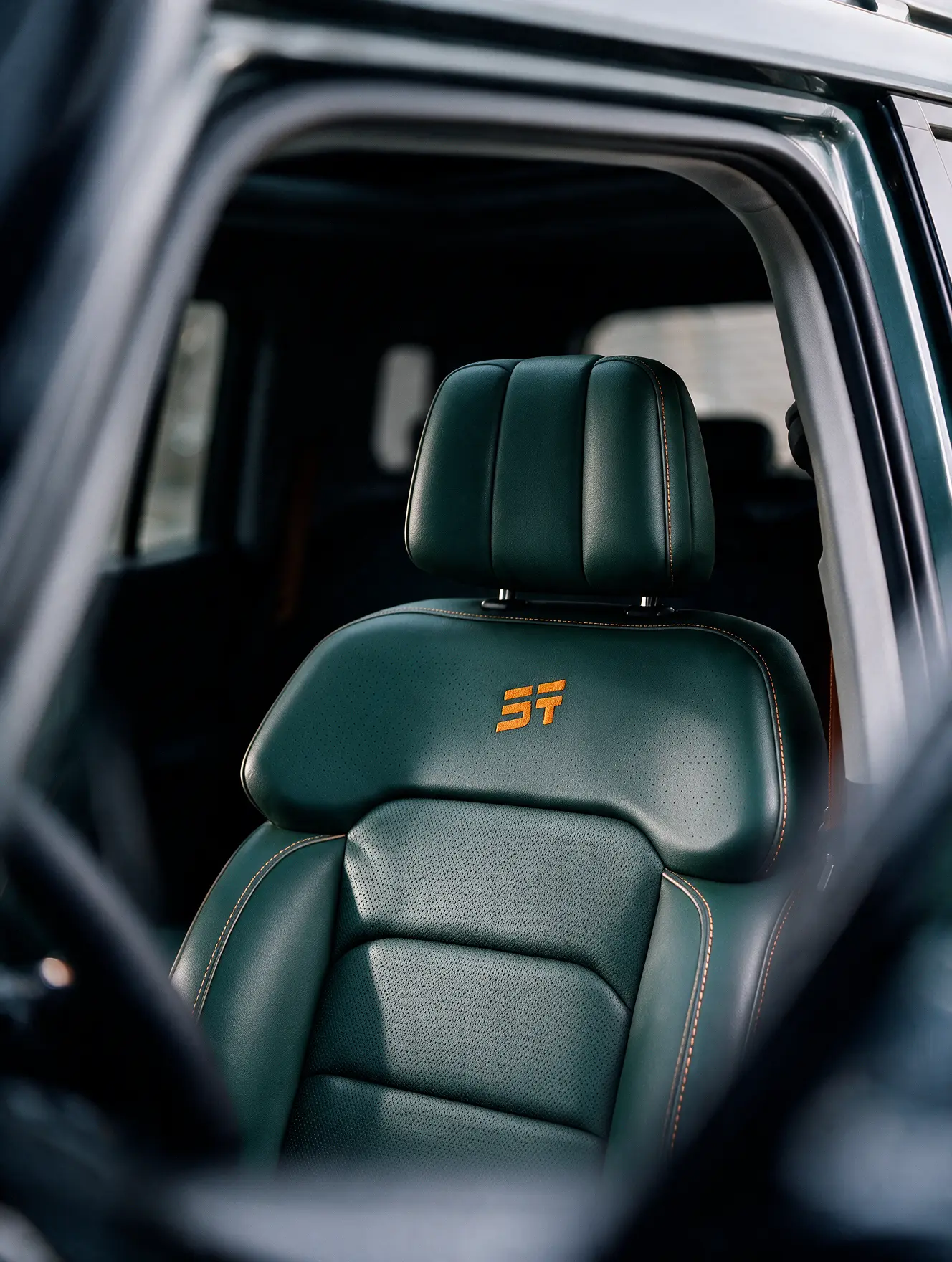 Green perforated leather seat with contrast stitching